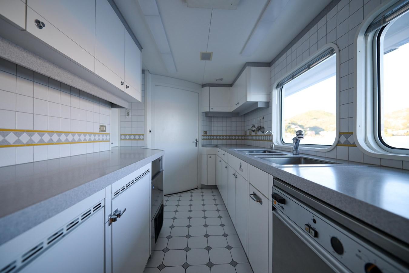 a kitchen with white cabinets aboard LADY BEATRICE Yacht for Sale