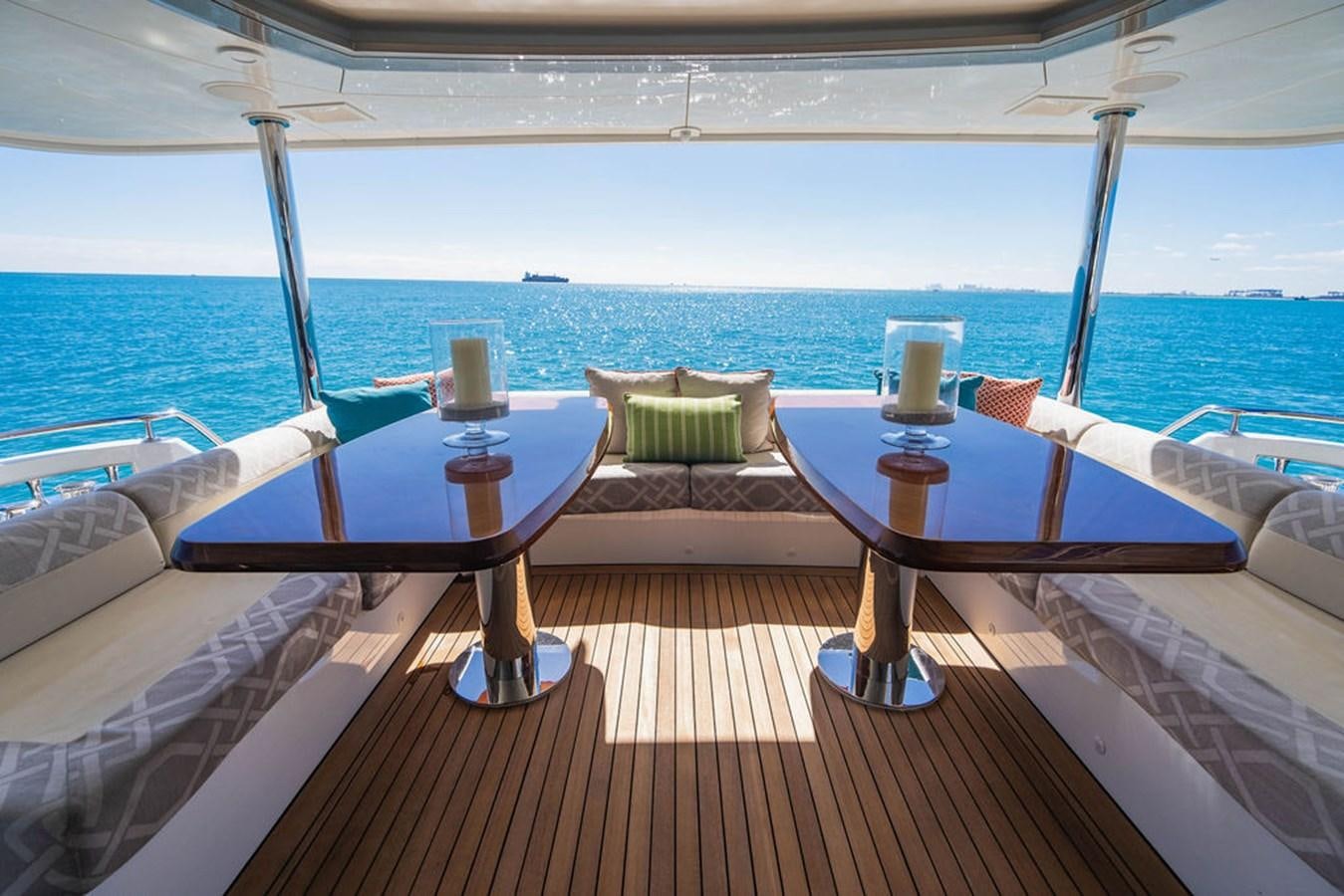 a table on a deck overlooking the ocean aboard FAR NIENTE Yacht for Sale