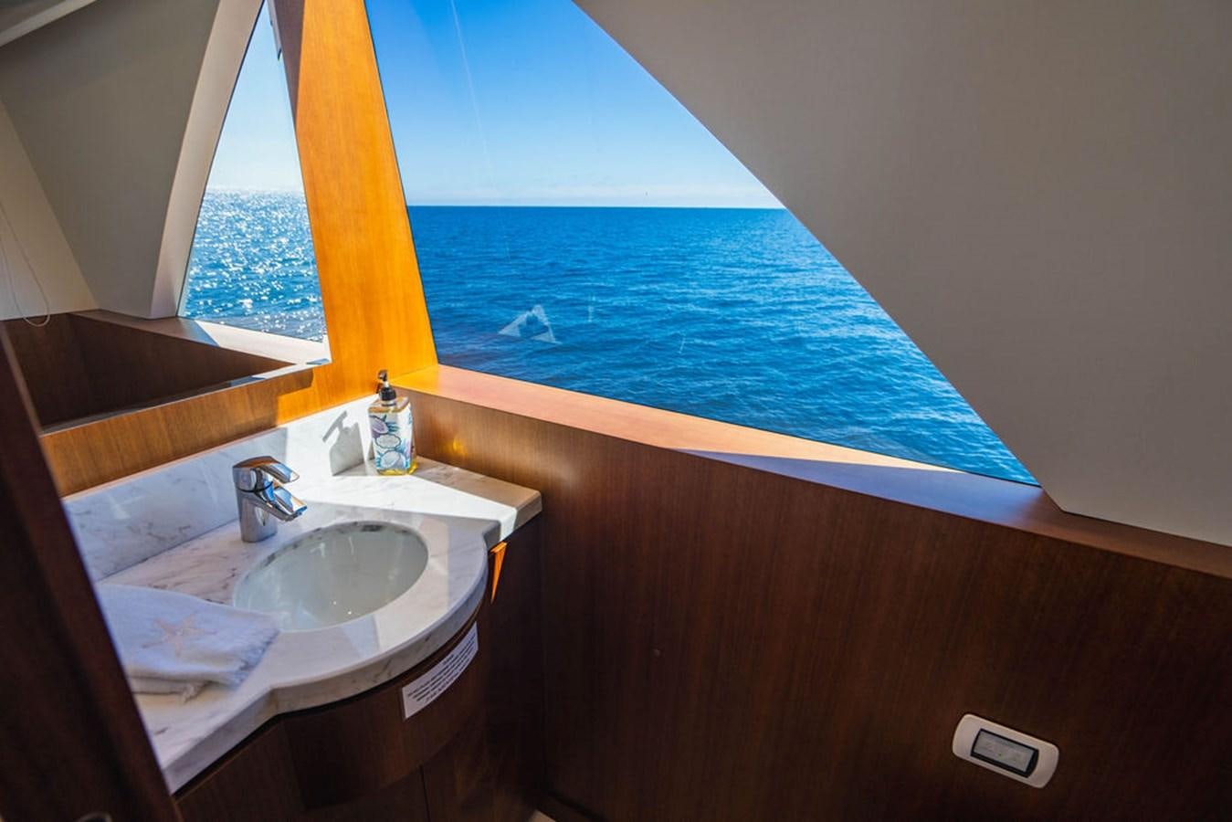 a bathroom with a sink and a window aboard FAR NIENTE Yacht for Sale