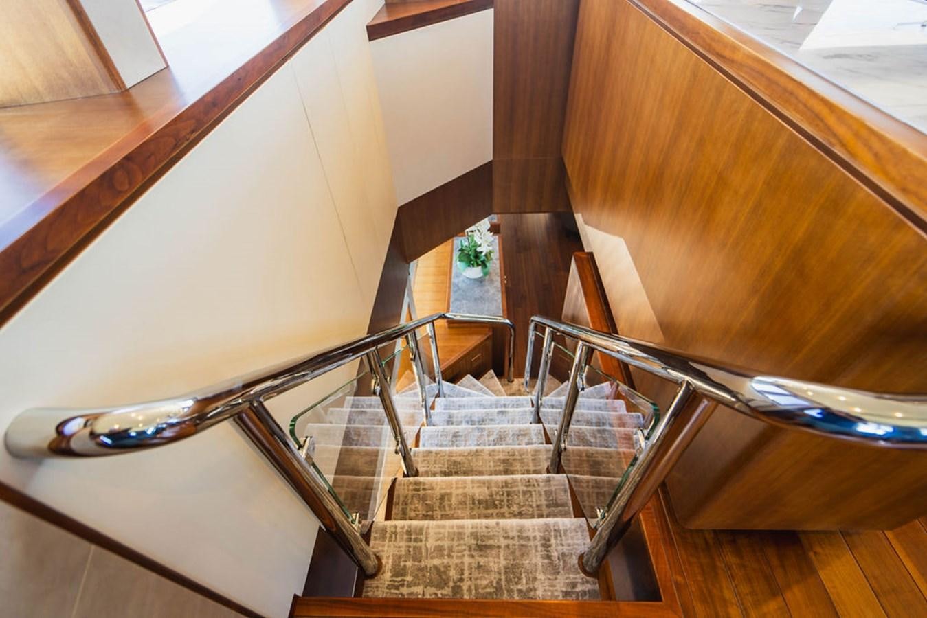 a staircase with a glass railing aboard FAR NIENTE Yacht for Sale