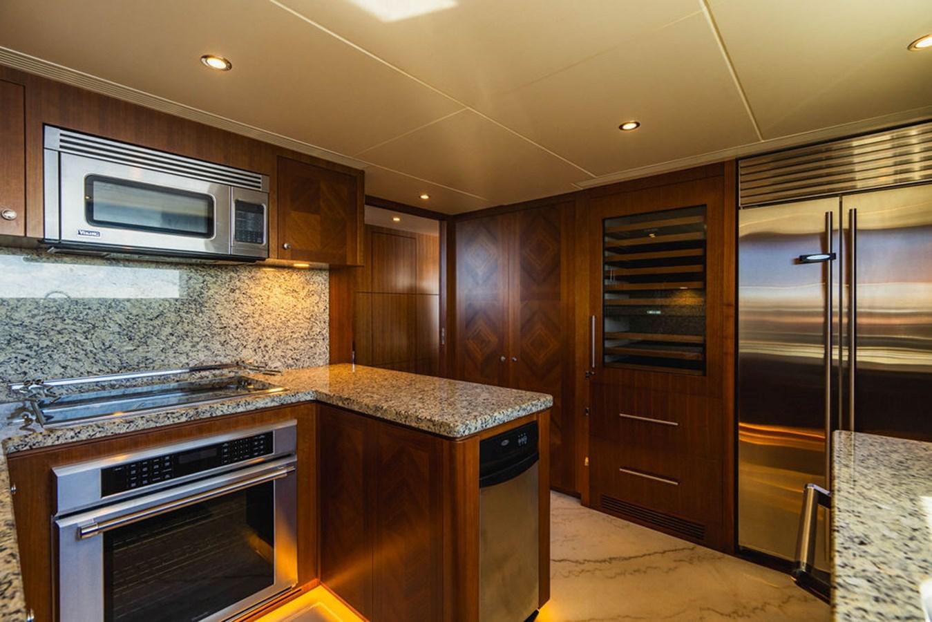a kitchen with wooden cabinets aboard FAR NIENTE Yacht for Sale