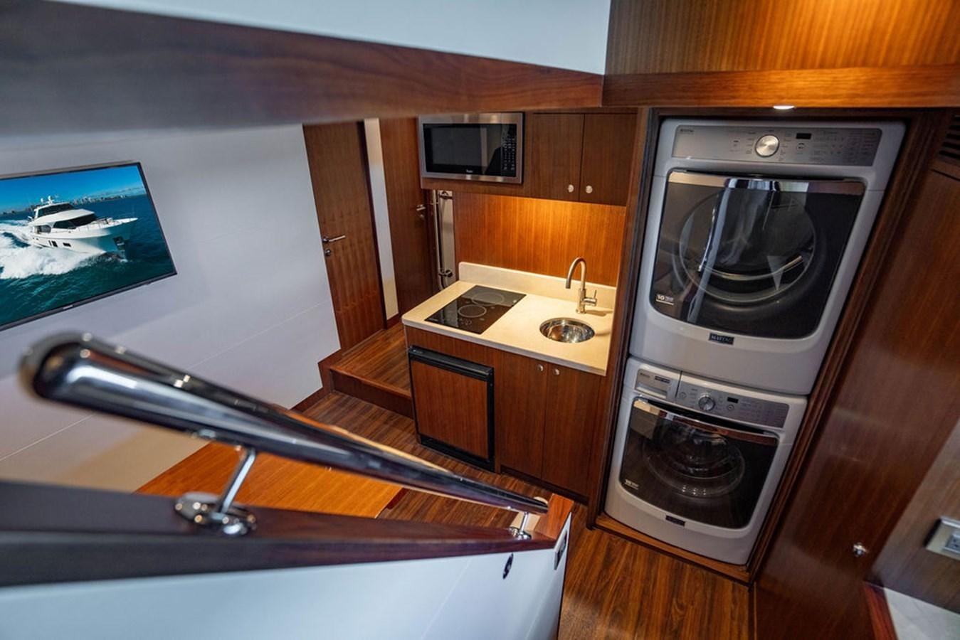 a kitchen with a stove and a television aboard FAR NIENTE Yacht for Sale