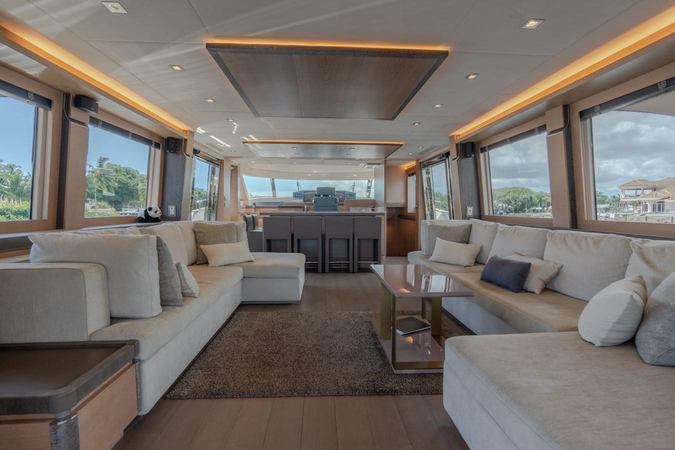 a living room with a couch and a table aboard PANDA Yacht for Sale