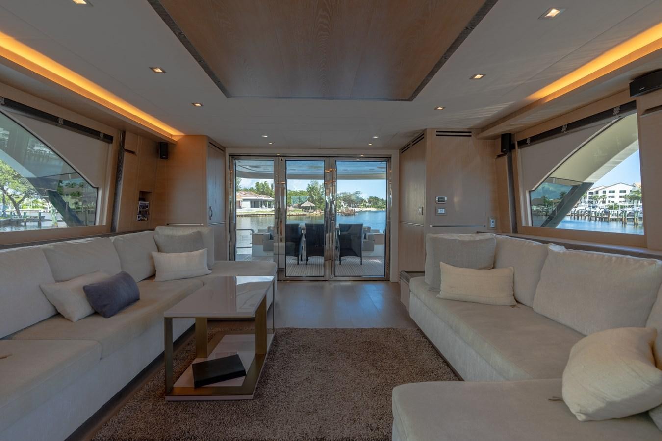 a living room with a large window aboard PANDA Yacht for Sale