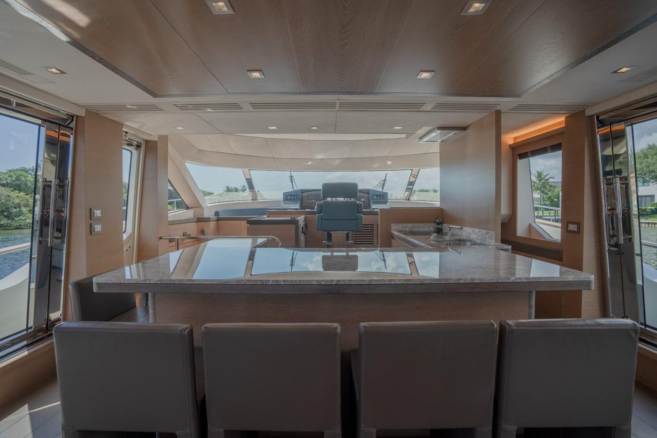 a large room with a large table and chairs aboard PANDA Yacht for Sale