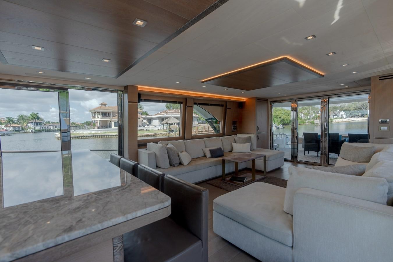 a living room with a large glass window aboard PANDA Yacht for Sale