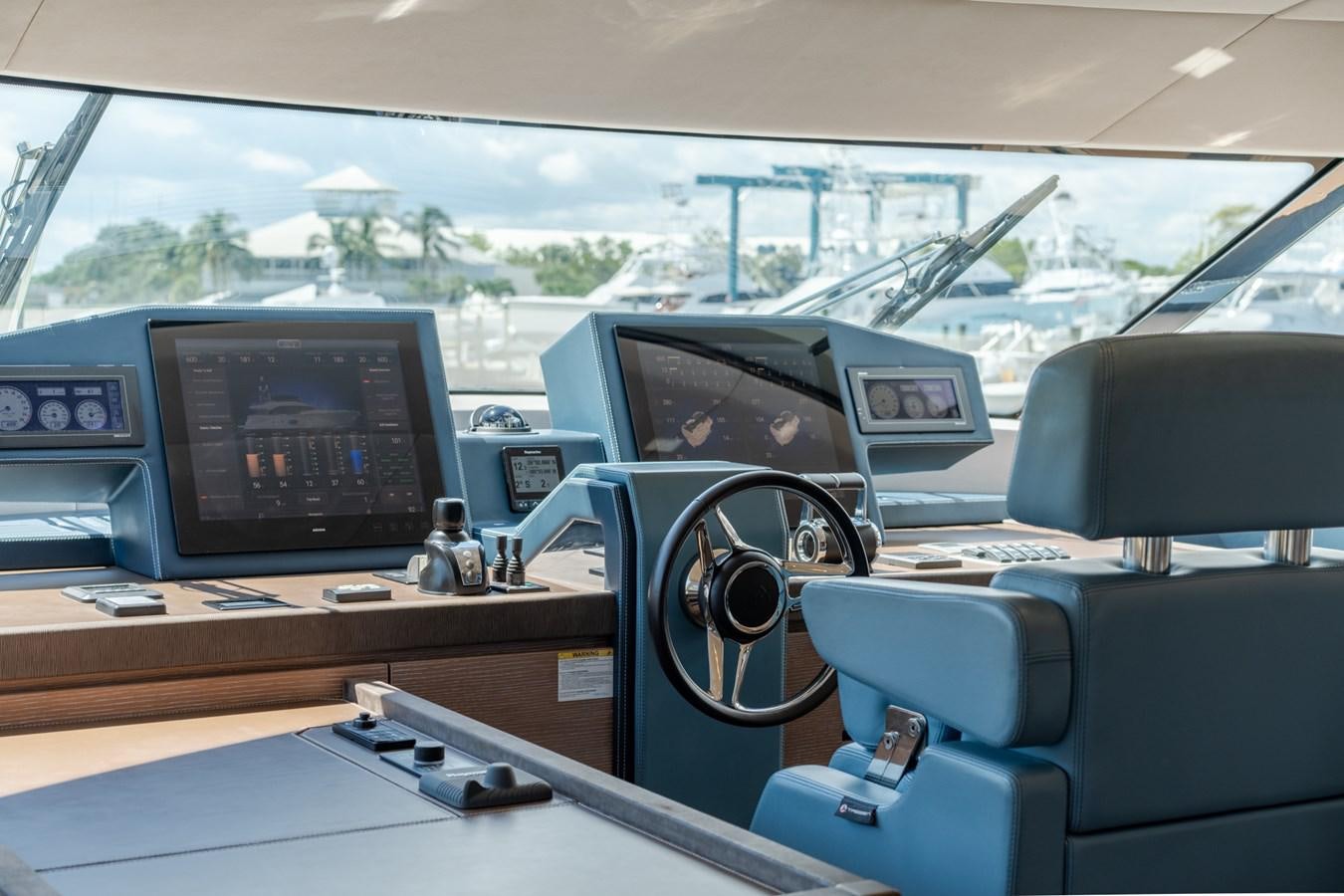 a car with a computer monitor and a television on it aboard PANDA Yacht for Sale