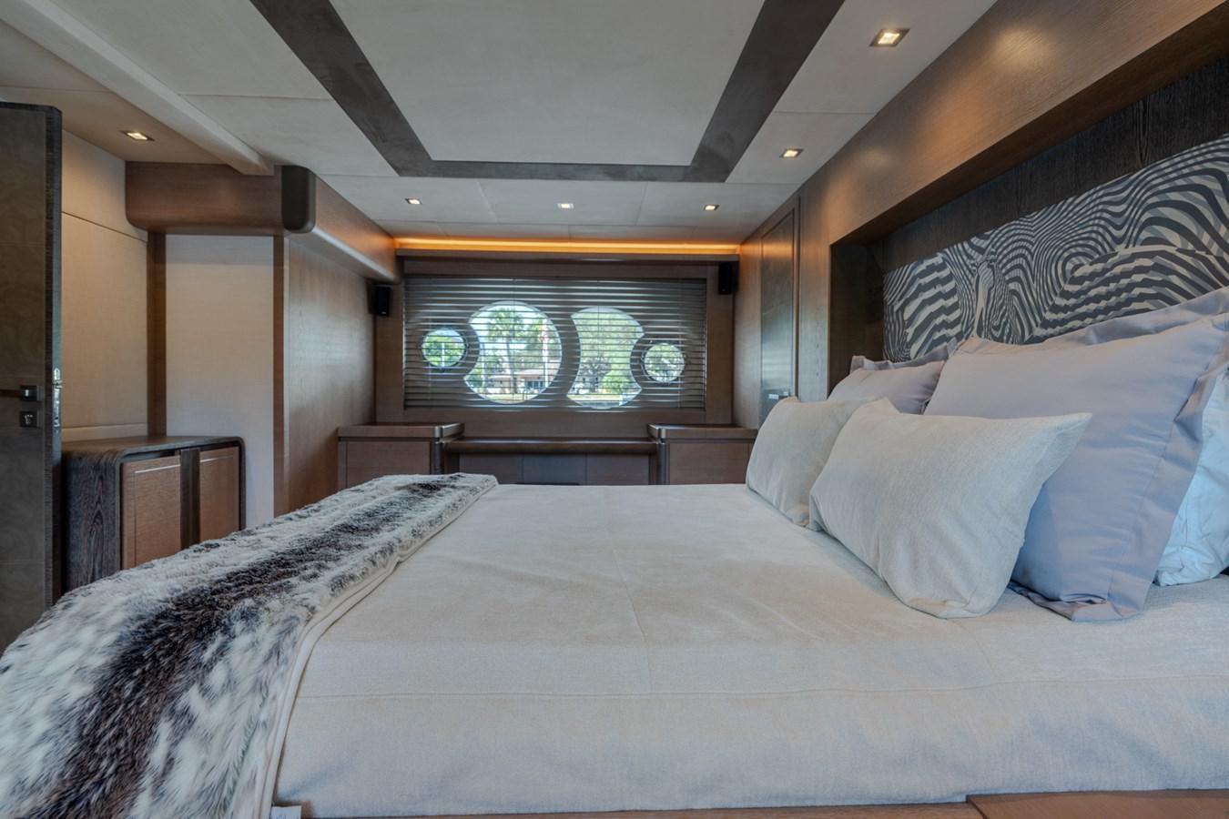 a room with a bed and a window aboard PANDA Yacht for Sale