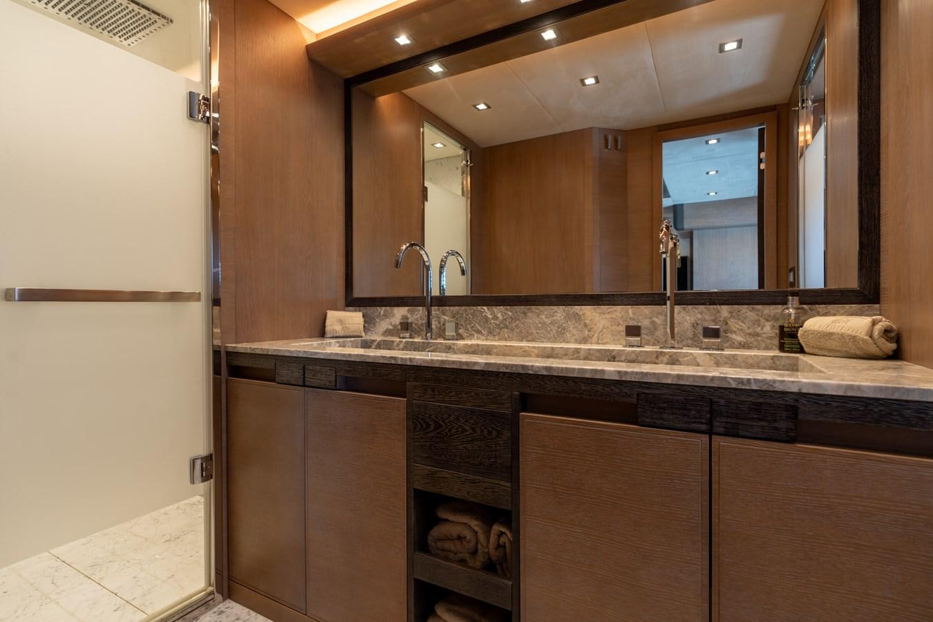 a bathroom with a large mirror aboard PANDA Yacht for Sale