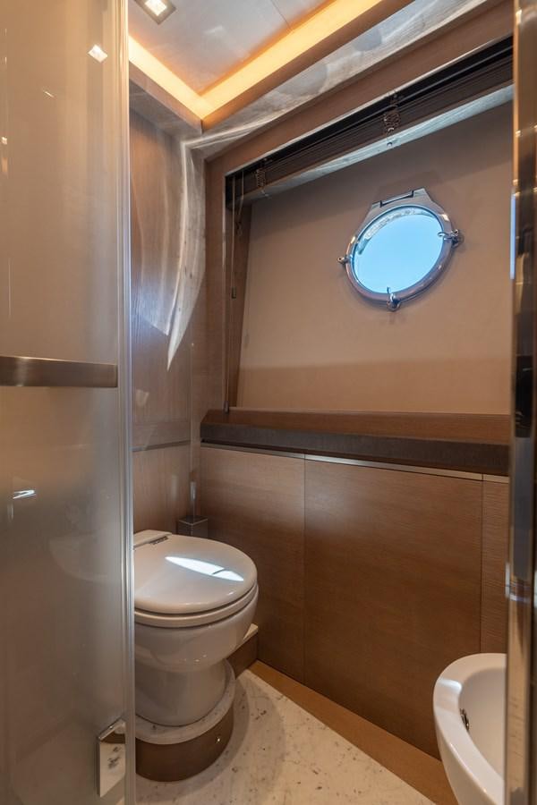 a bathroom with a toilet and a mirror aboard PANDA Yacht for Sale
