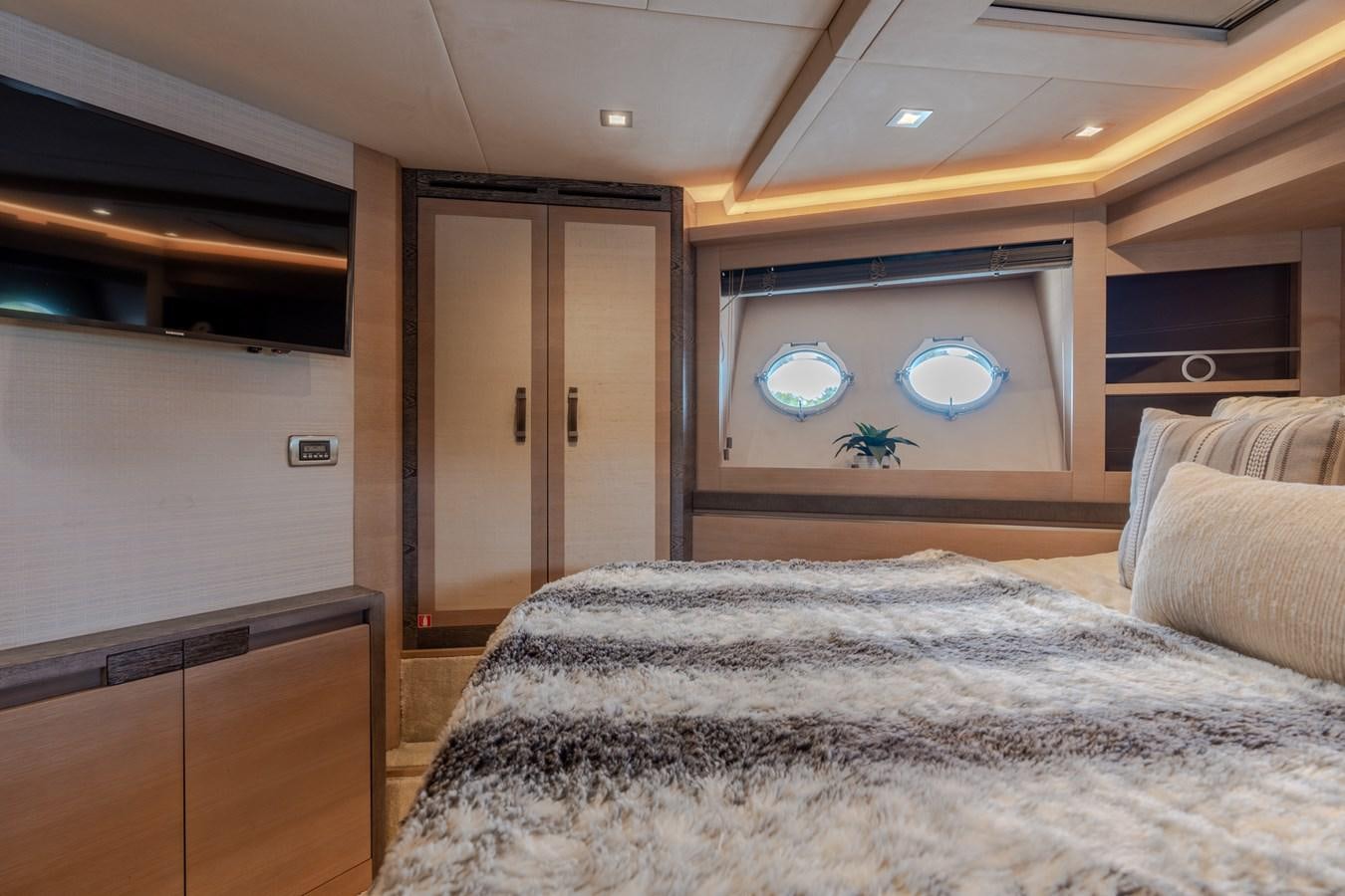 a bedroom with a bed and a door aboard PANDA Yacht for Sale