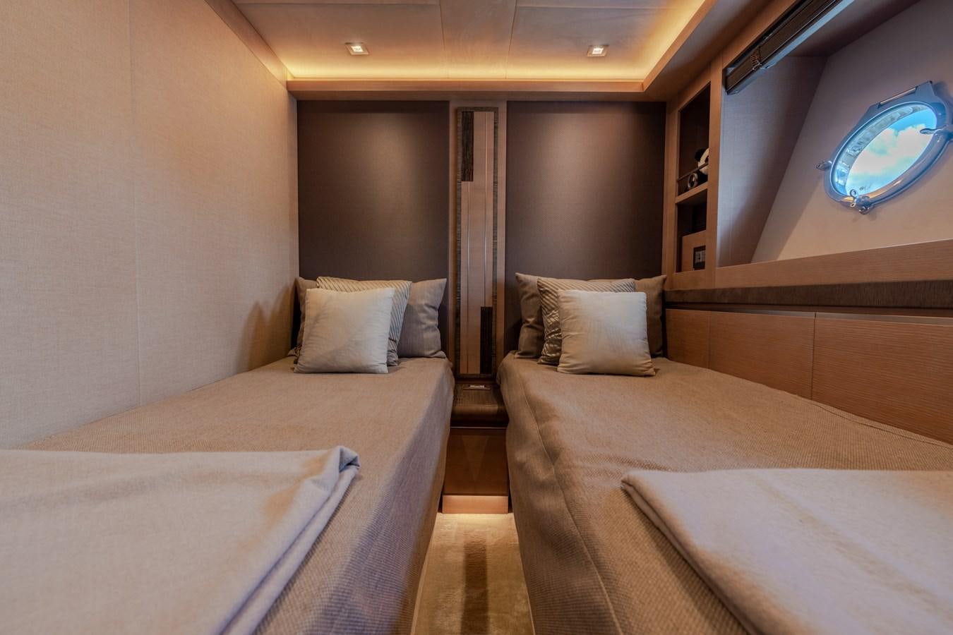 a room with beds and a window aboard PANDA Yacht for Sale