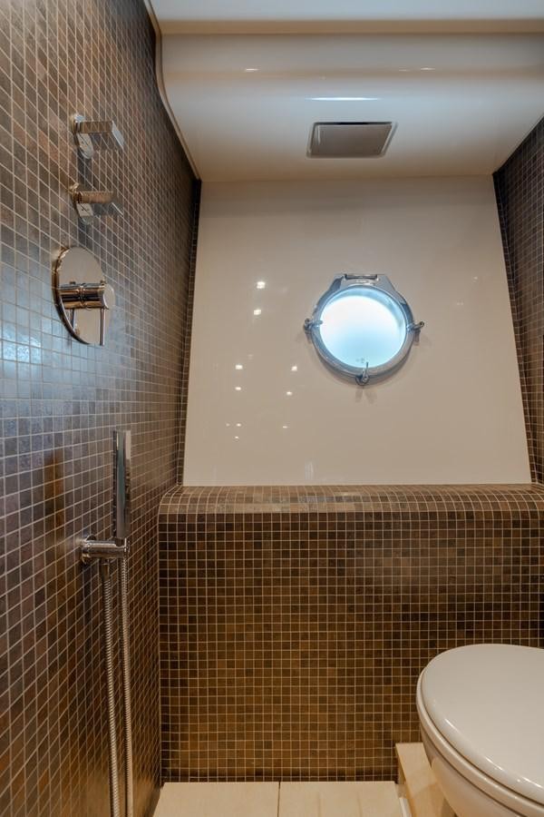 a bathroom with a tile floor aboard PANDA Yacht for Sale