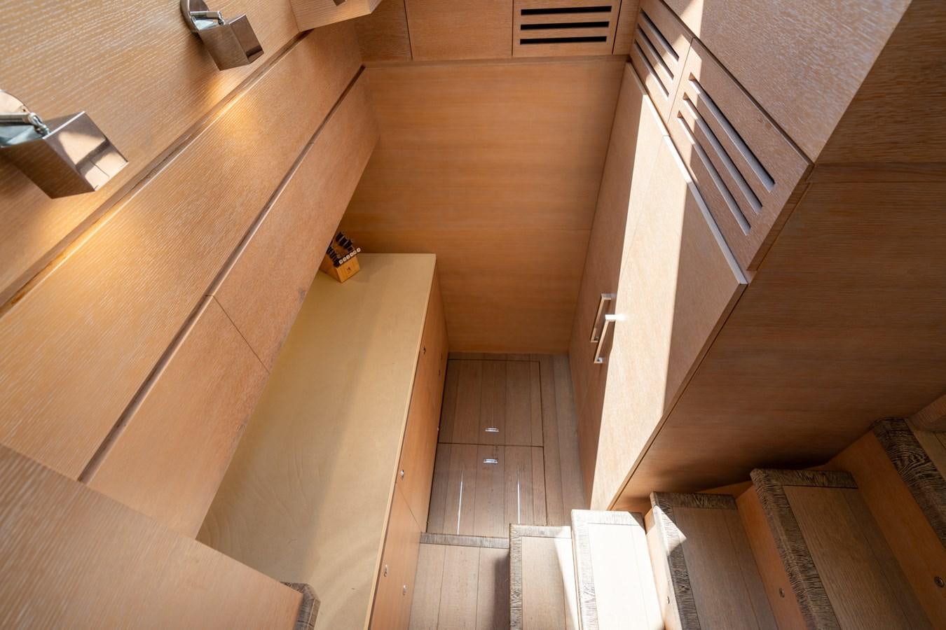 a room with wooden floors and white walls aboard PANDA Yacht for Sale