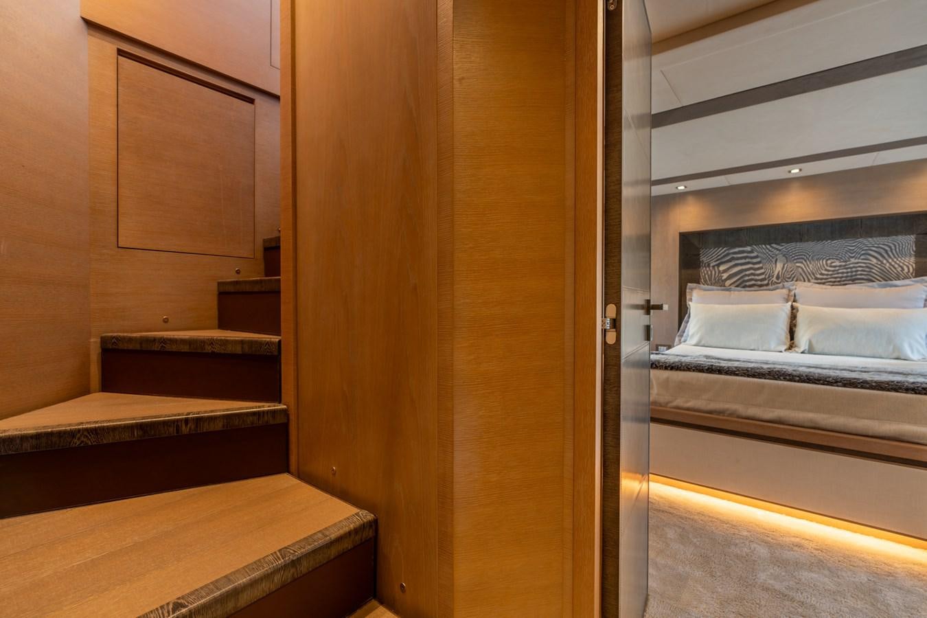 a room with a bed and a closet aboard PANDA Yacht for Sale