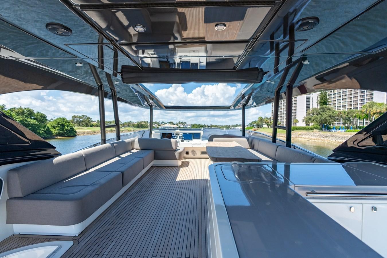 a deck with a view of the water and a boat aboard PANDA Yacht for Sale