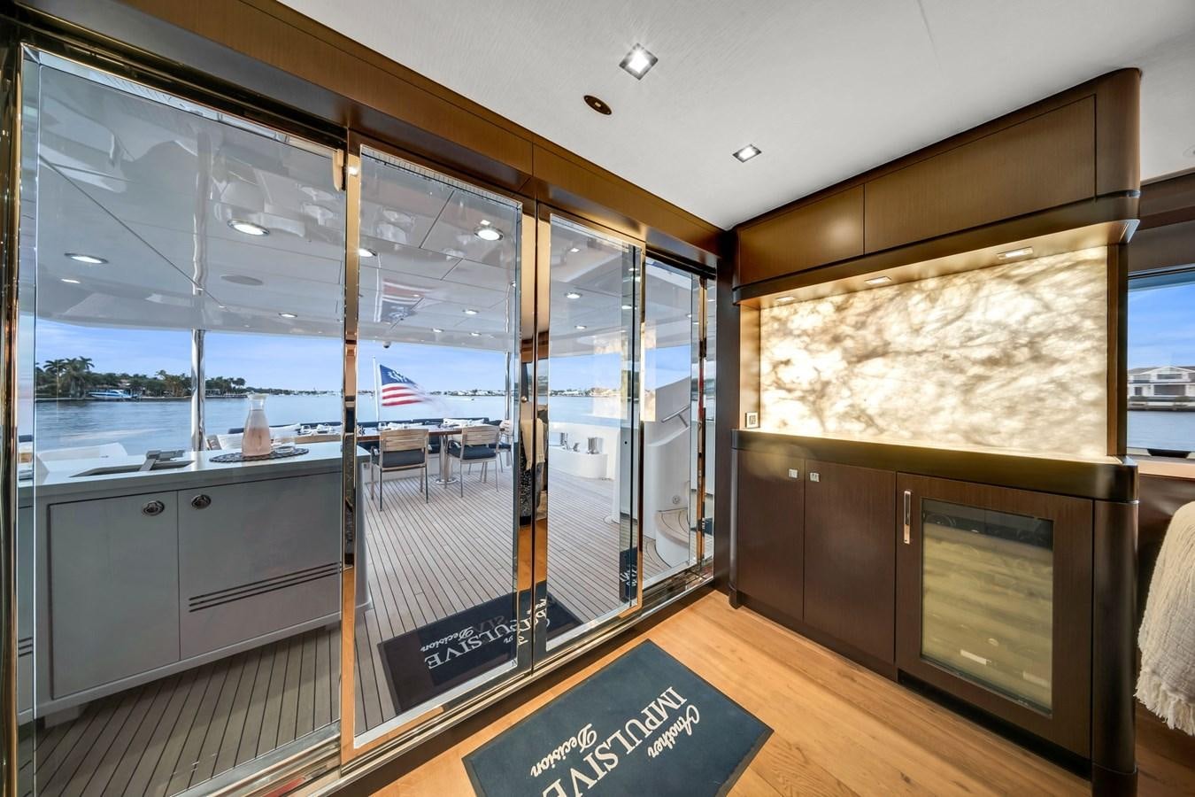 a room with glass walls and a large window with a view of the water aboard ANOTHER IMPULSIVE DECISION Yacht for Sale