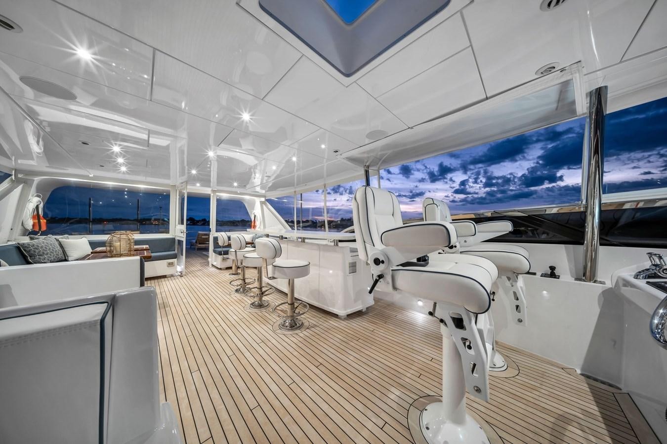 inside of a building with a large window and a large white table and chairs aboard ANOTHER IMPULSIVE DECISION Yacht for Sale