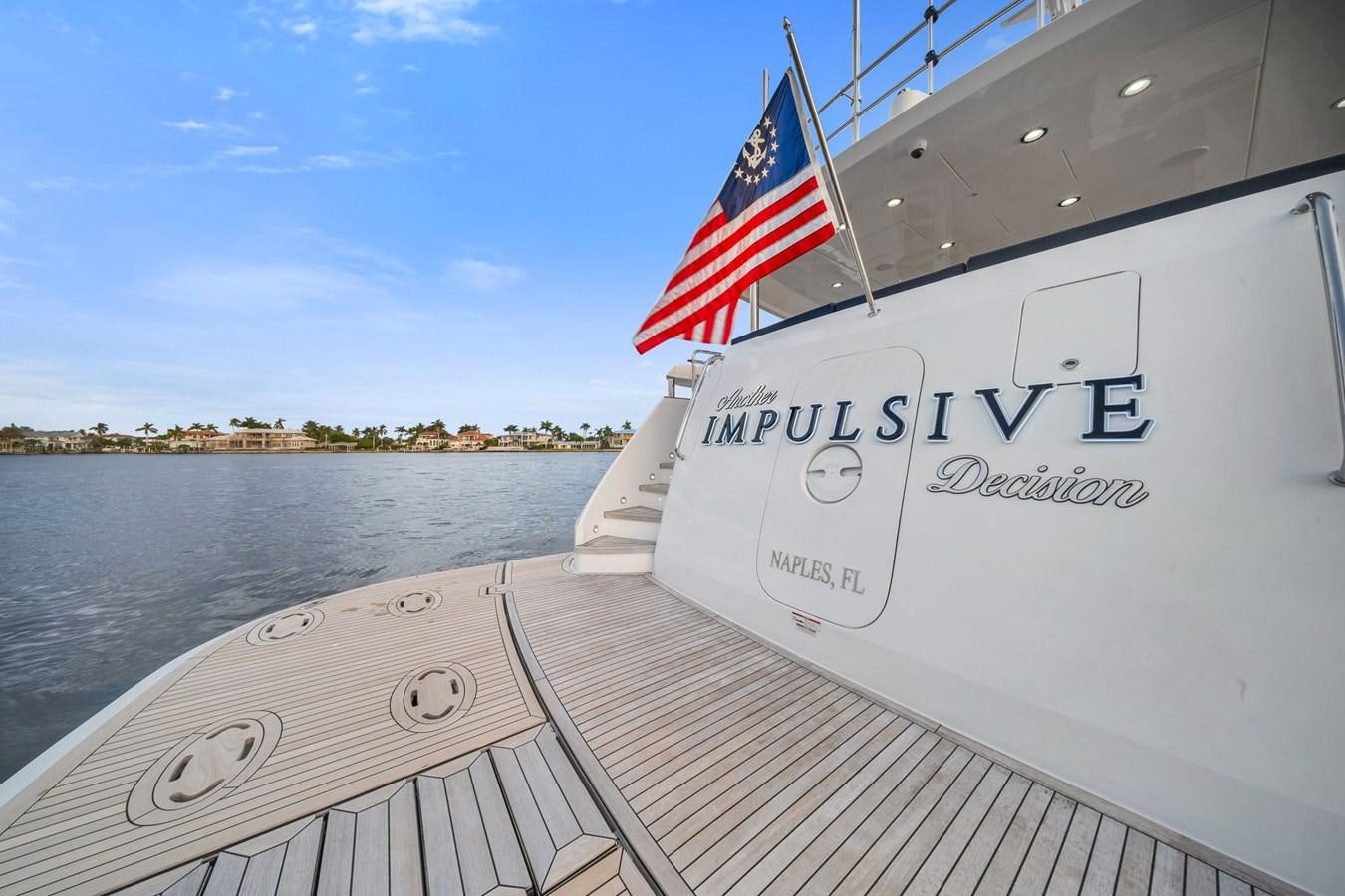 a boat with a flag on the front aboard ANOTHER IMPULSIVE DECISION Yacht for Sale
