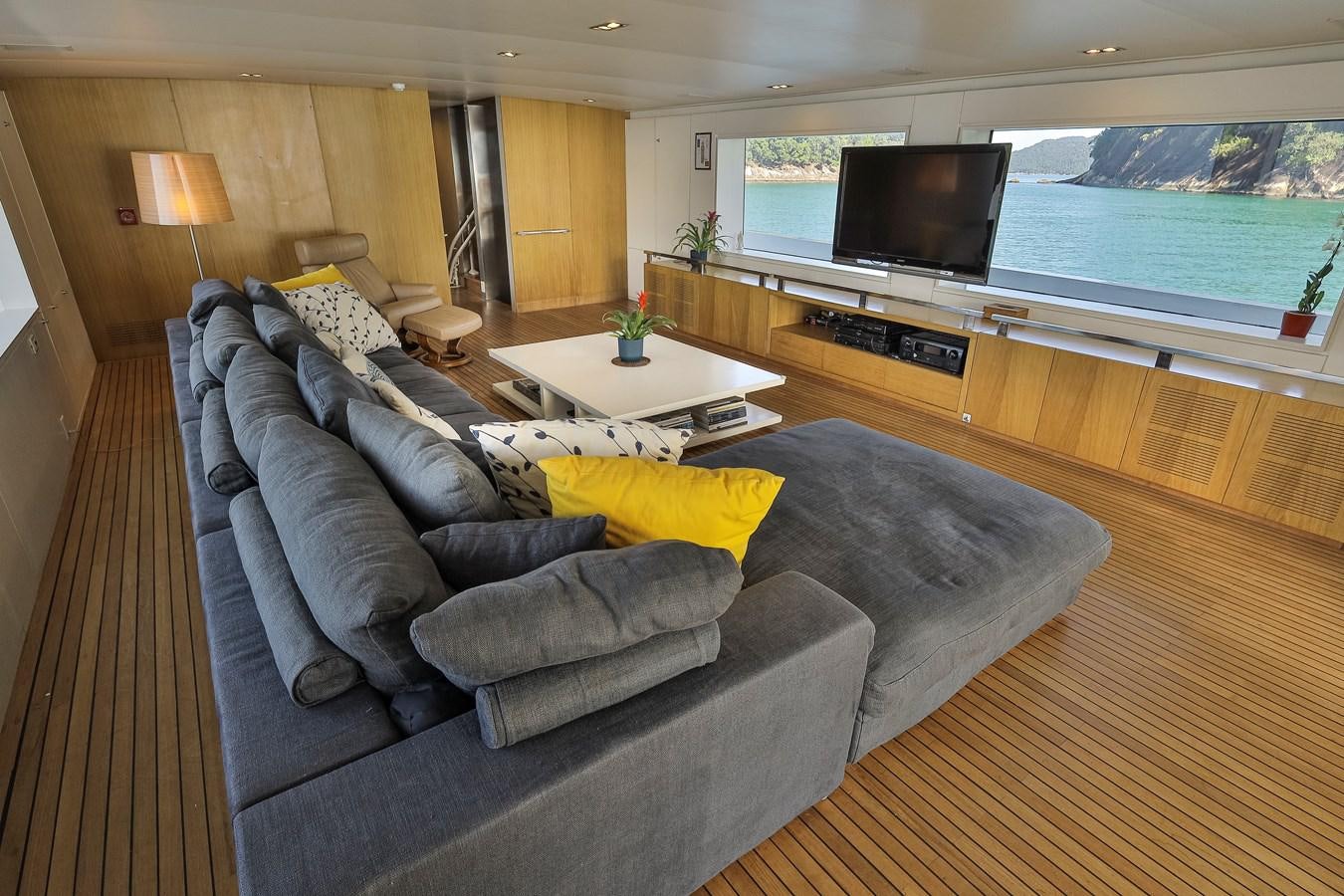 a living room with a large sofa aboard PAPA-GOLFE Yacht for Sale