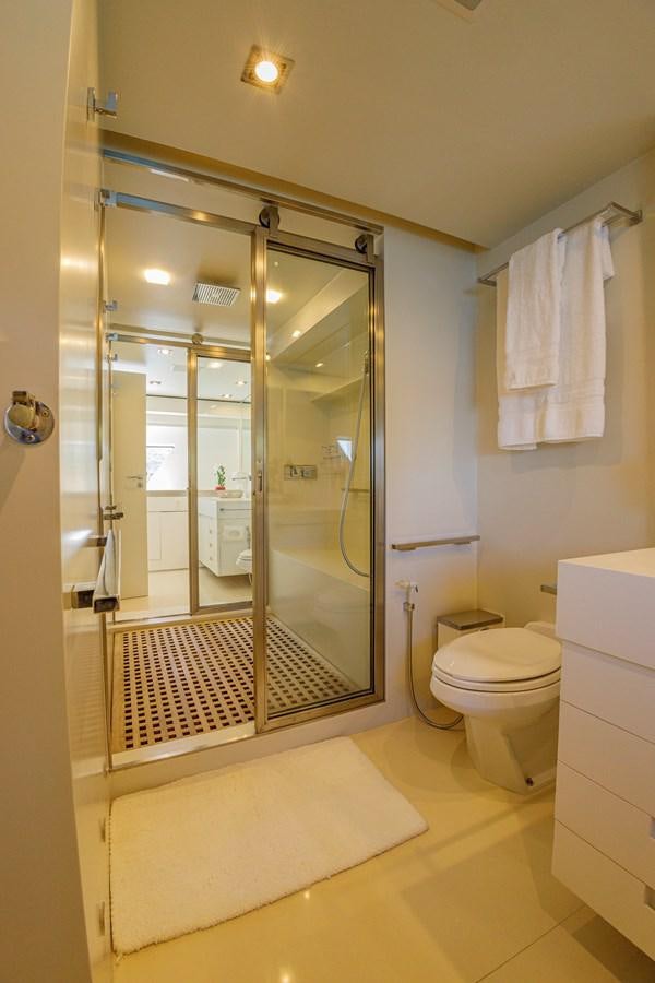 a bathroom with a glass shower aboard PAPA-GOLFE Yacht for Sale