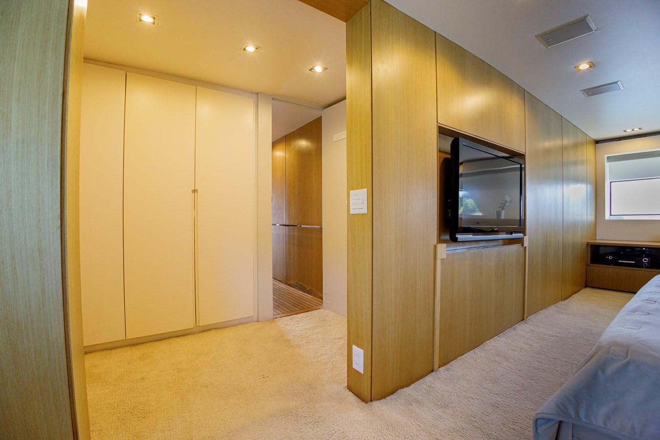 a room with a bed and a television aboard PAPA-GOLFE Yacht for Sale