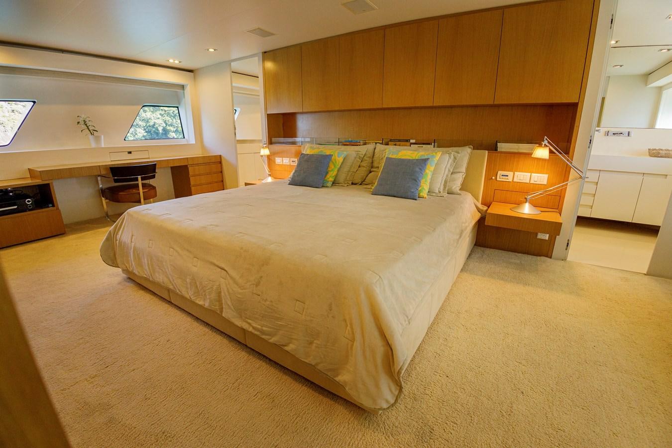 a bedroom with a bed and desk aboard PAPA-GOLFE Yacht for Sale