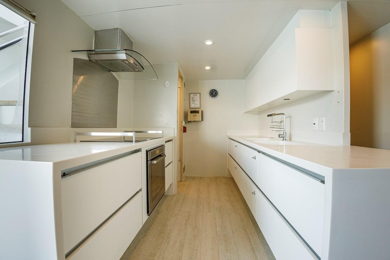 a kitchen with white cabinets aboard PAPA-GOLFE Yacht for Sale