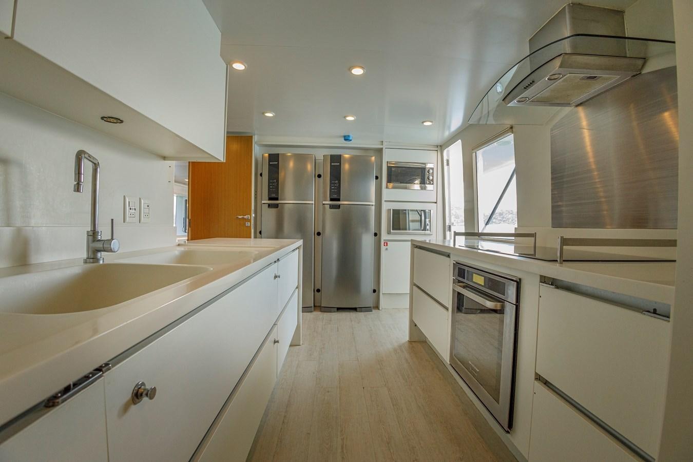 a kitchen with white cabinets aboard PAPA-GOLFE Yacht for Sale