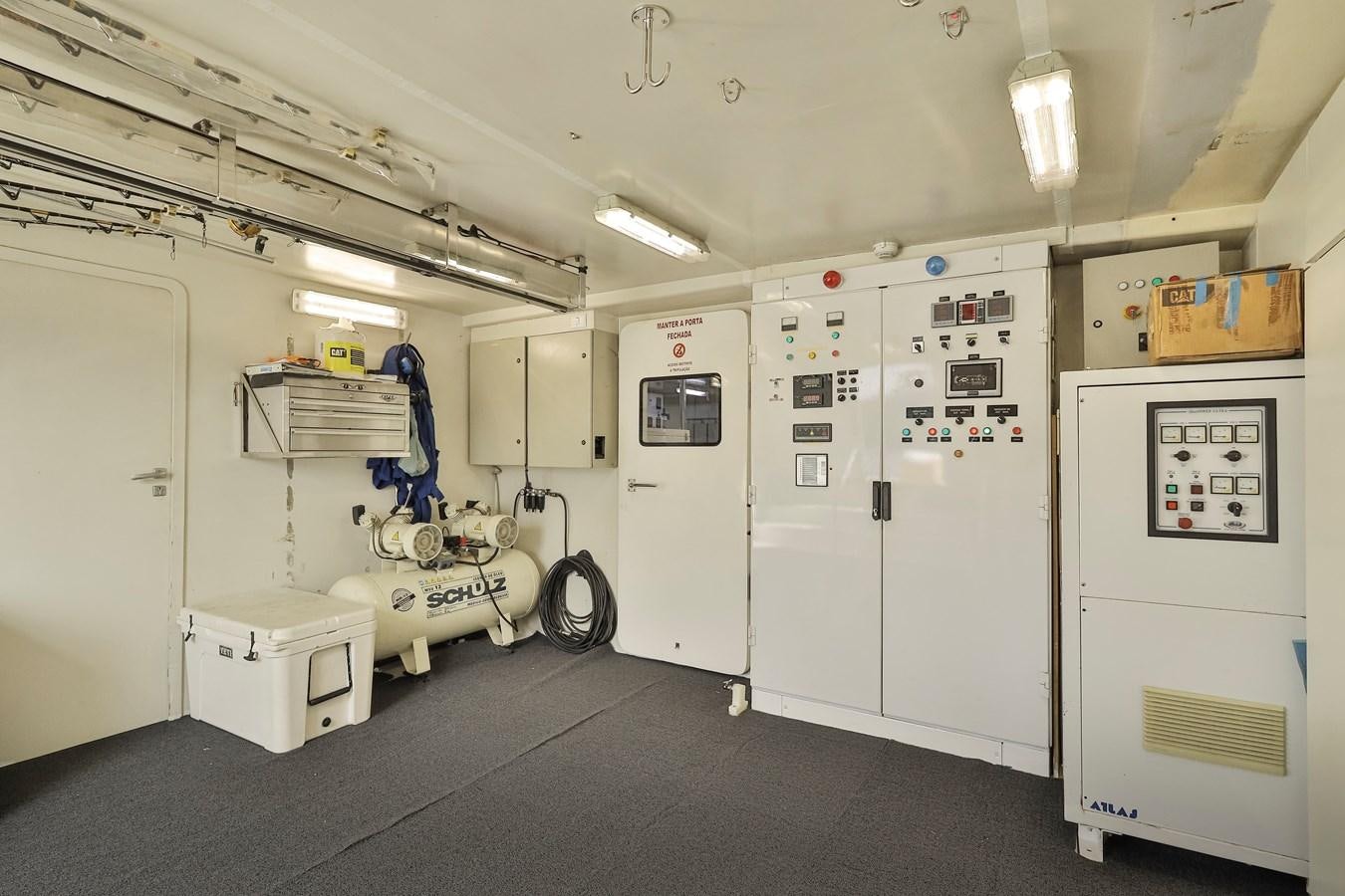 a room with white doors and a cart with a bike on it aboard PAPA-GOLFE Yacht for Sale