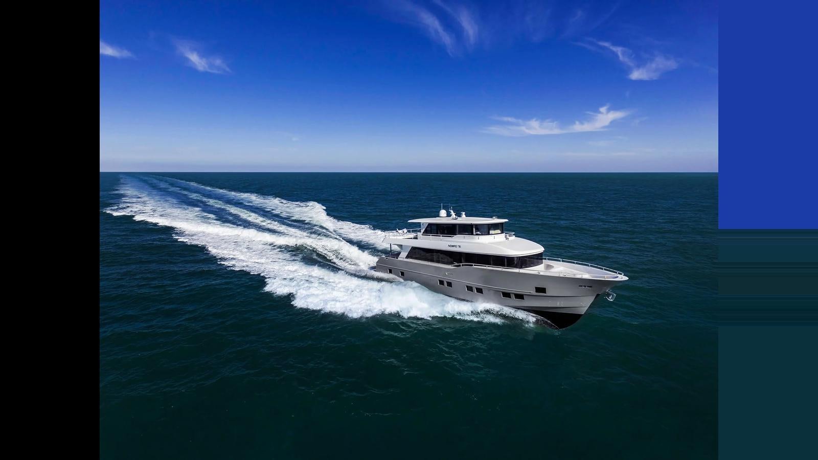 a white boat on the water aboard NOMAD 70 SUV Yacht for Sale