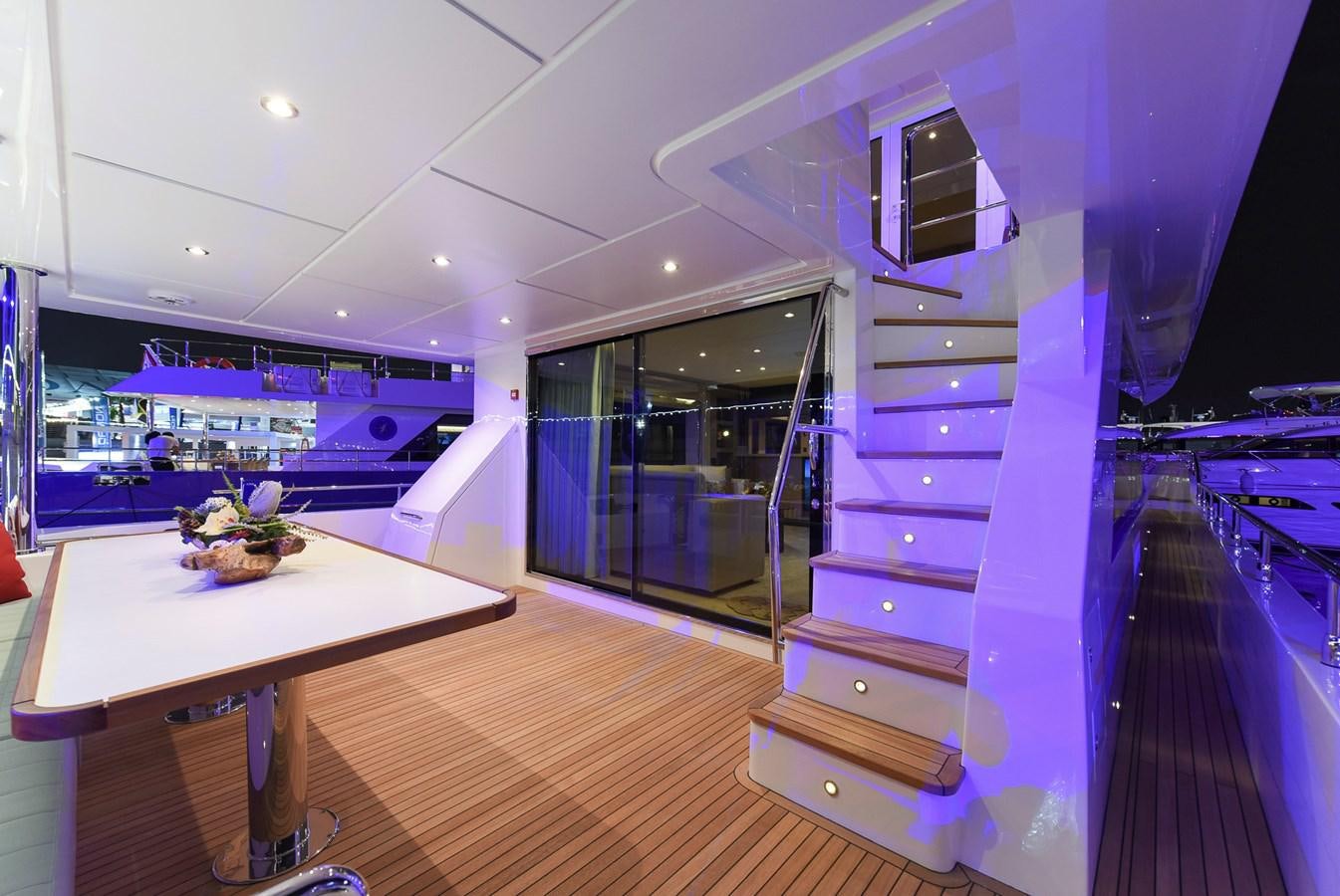 a room with a table and a large mirror aboard NOMAD 70 SUV Yacht for Sale