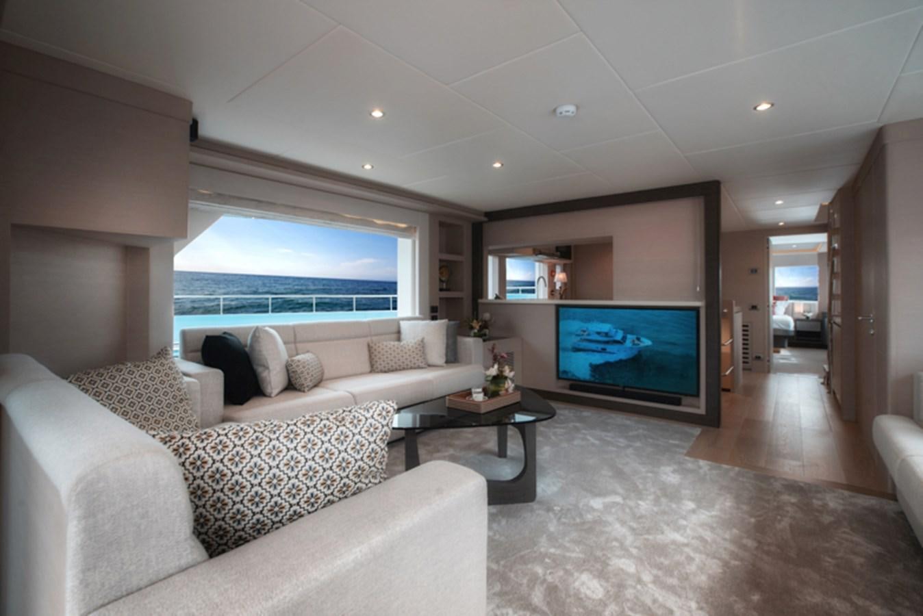 a living room with a large screen aboard NOMAD 70 SUV Yacht for Sale