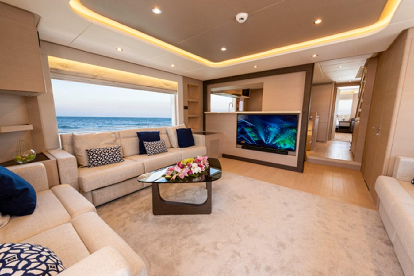 a living room with a large television aboard NOMAD 70 SUV Yacht for Sale