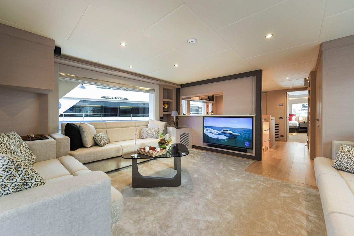 a living room with a large television aboard NOMAD 70 SUV Yacht for Sale