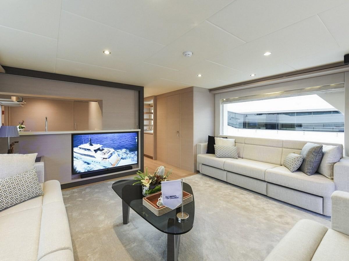 a living room with a large screen aboard NOMAD 70 SUV Yacht for Sale