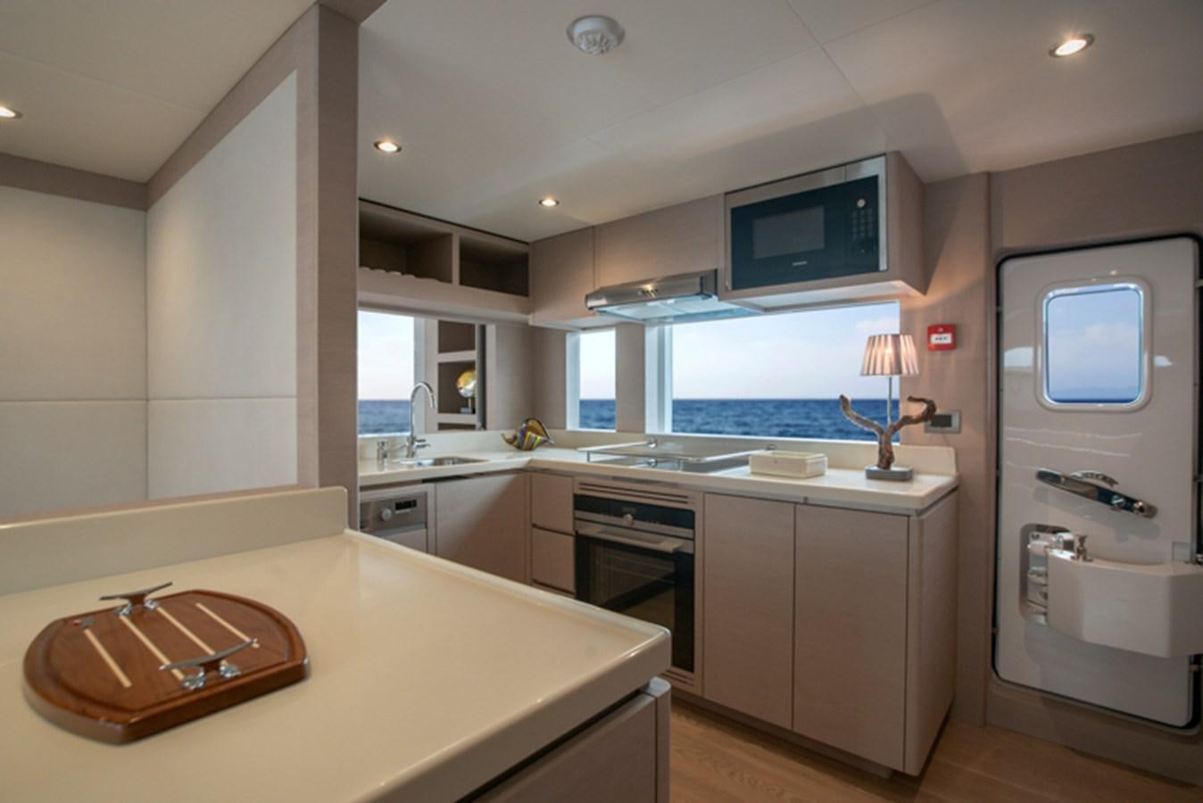 a kitchen with a sink and a microwave oven aboard NOMAD 70 SUV Yacht for Sale