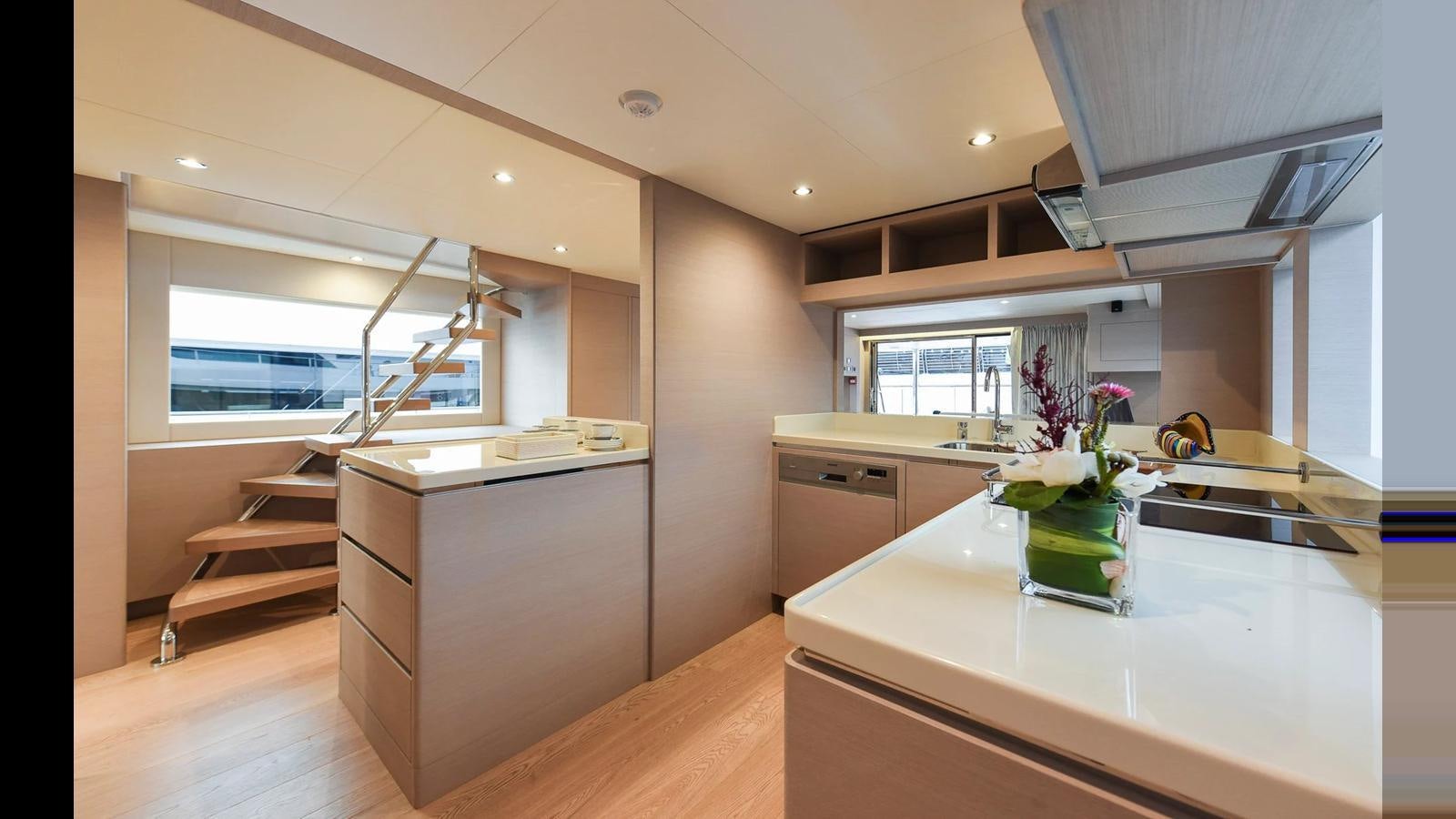 a kitchen with white cabinets aboard NOMAD 70 SUV Yacht for Sale