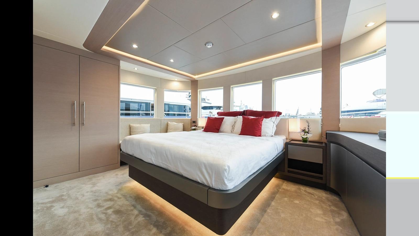 a large bedroom with a large bed aboard NOMAD 70 SUV Yacht for Sale