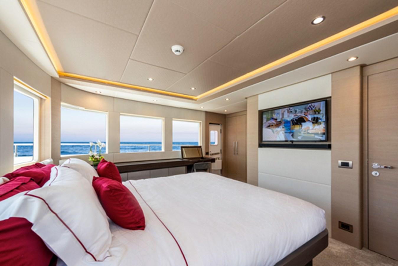 a room with a bed and a television aboard NOMAD 70 SUV Yacht for Sale