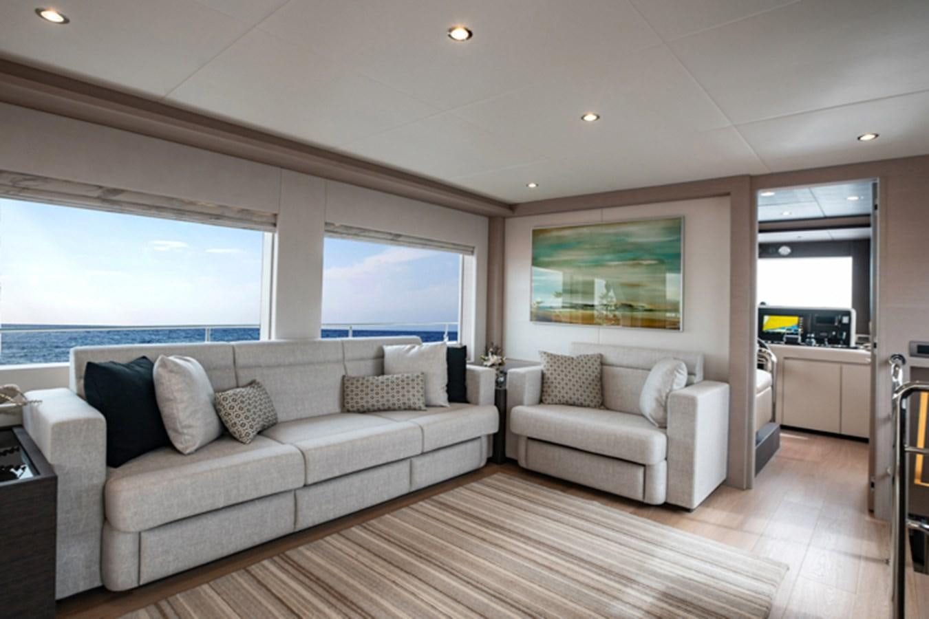 a living room with a large window aboard NOMAD 70 SUV Yacht for Sale