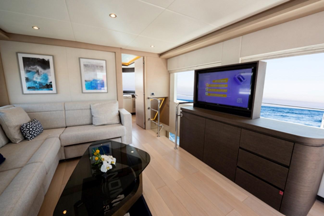 a living room with a large television aboard NOMAD 70 SUV Yacht for Sale