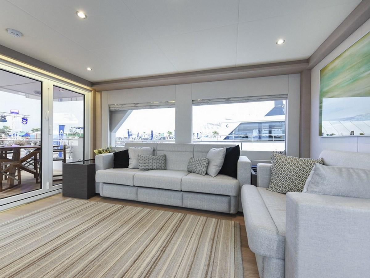 a living room with a large window aboard NOMAD 70 SUV Yacht for Sale