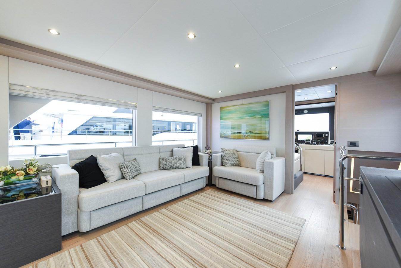 a living room with a large window aboard NOMAD 70 SUV Yacht for Sale