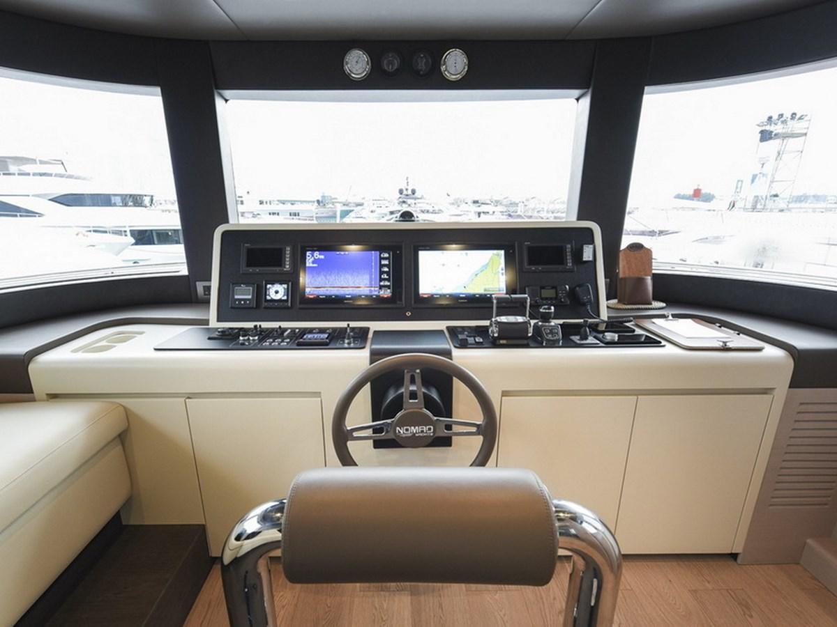 a room with computers and chairs aboard NOMAD 70 SUV Yacht for Sale