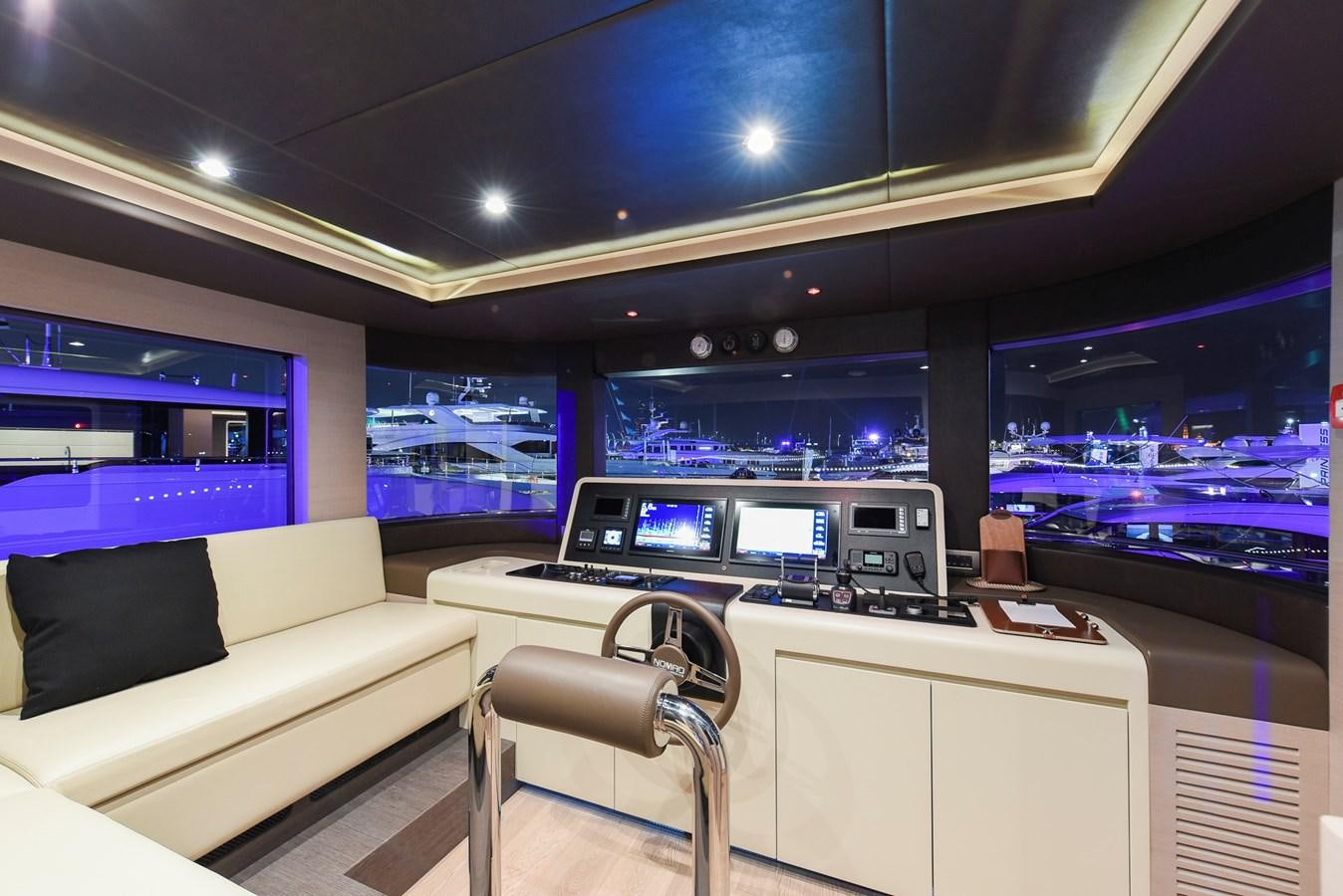 a room with a couch and a desk with a computer on it aboard NOMAD 70 SUV Yacht for Sale