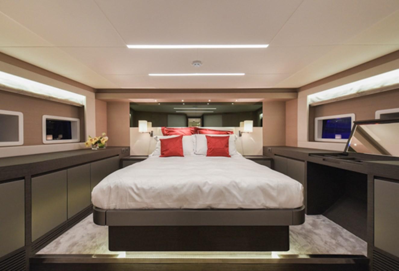 a bedroom with a bed and desk aboard NOMAD 70 SUV Yacht for Sale