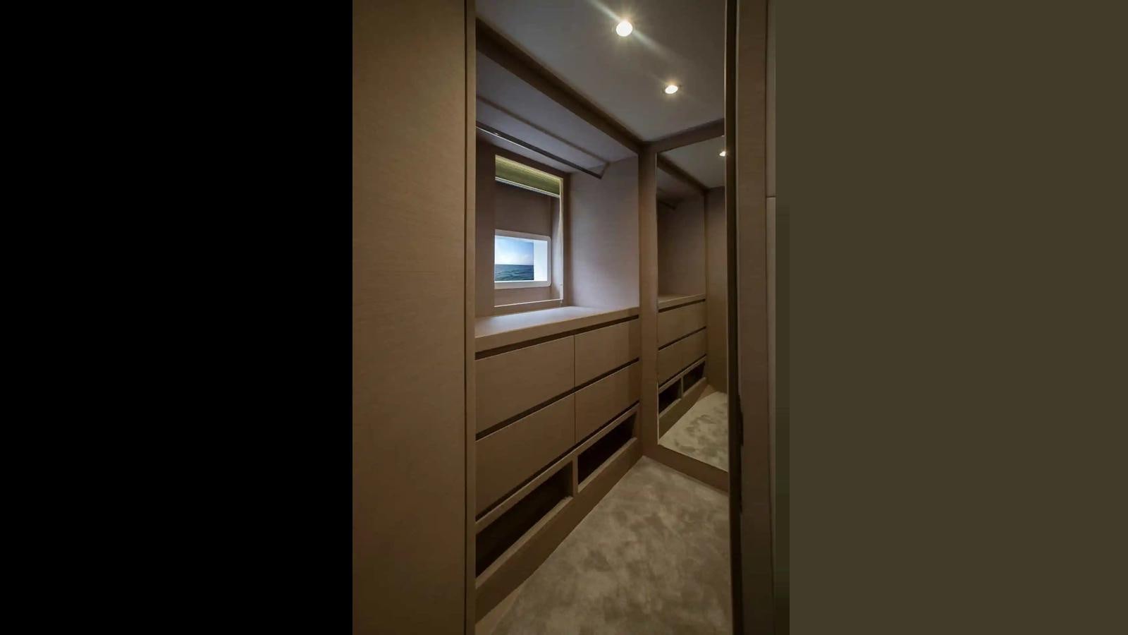 a hallway with a window and a door aboard NOMAD 70 SUV Yacht for Sale