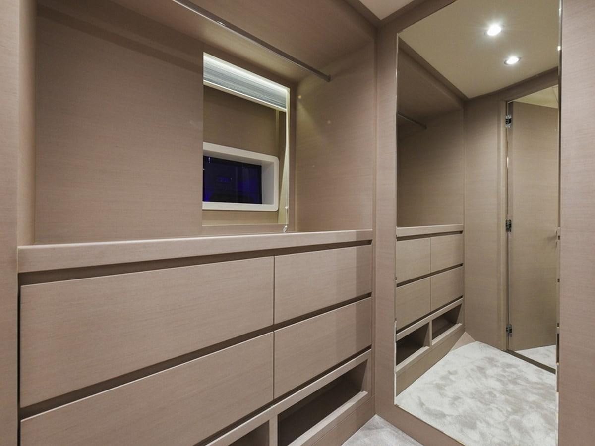a room with a window and a closet aboard NOMAD 70 SUV Yacht for Sale