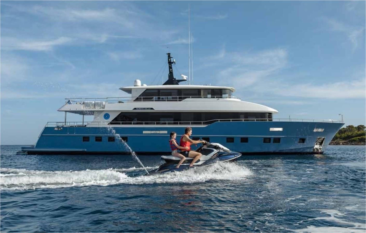 a couple of people on a boat in the water aboard NOMAD 95 SUV Yacht for Sale